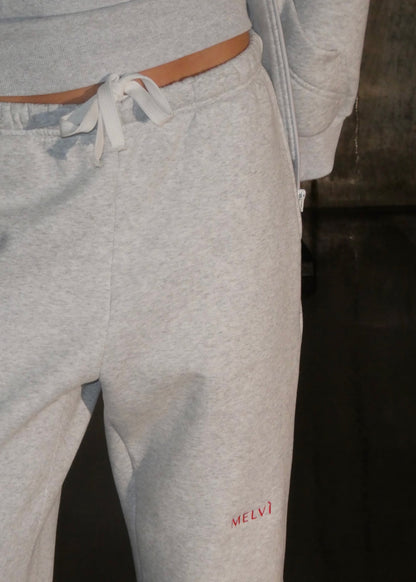 Gray sweatpants with a brand logo on a dark background